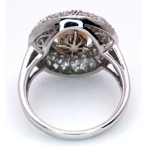 72 - AN 18K WHITE GOLD DIAMOND & PEARL SET RING. 6.1G, SIZE N. Ref: TAN 7009