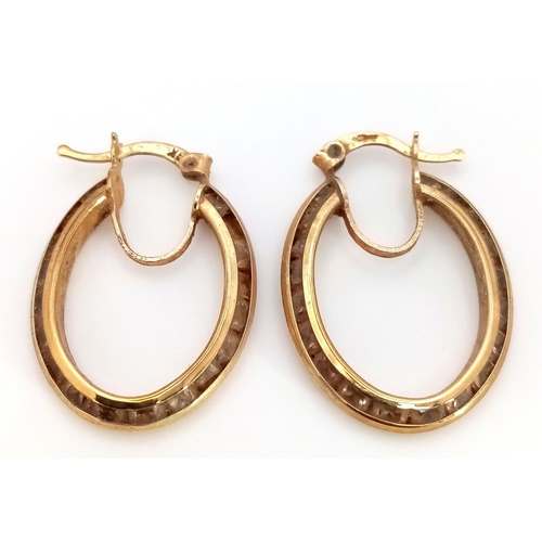 449 - A Pair of 9K Yellow Gold Oval Hoop Earrings. 2.5cm. 4.5g.