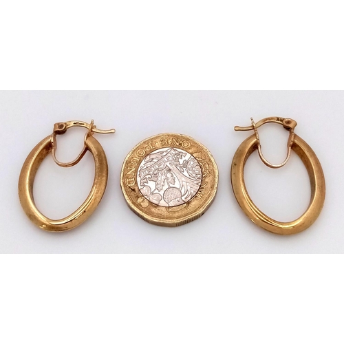 449 - A Pair of 9K Yellow Gold Oval Hoop Earrings. 2.5cm. 4.5g.