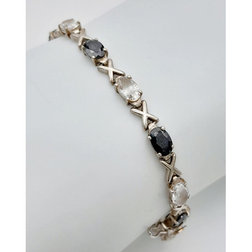 1018 - A Sterling Silver Black Onyx and Clear Stone Tennis Love Bracelet 20cm Length. Set with Sixteen 6mm ... 