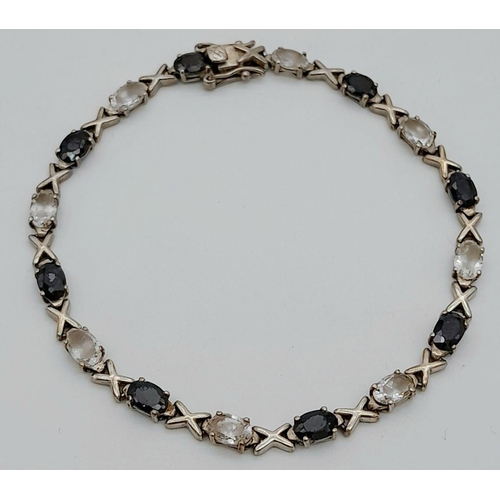 1018 - A Sterling Silver Black Onyx and Clear Stone Tennis Love Bracelet 20cm Length. Set with Sixteen 6mm ... 