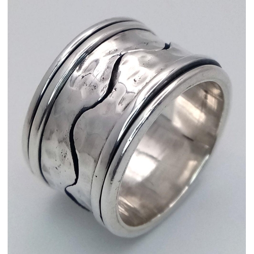 1025 - A Heavy Wide Band Sterling Silver Detailed Spinner Ring Size S. The Ring Measures 1.5cm Wide and wei... 