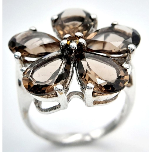 1064 - A Sterling Silver Pear Cut Smoky Quartz Flower Design Ring Size Q. The Crown Measures 2.2cm Diameter... 