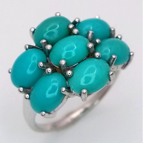 1113 - A Sterling Silver Turquoise Set Cluster Ring Size O. The Crown Measures 2x1.5cm. The Ring Weighs 3.6... 