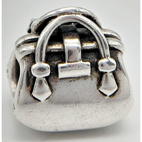 1114 - A PANDORA STERLING SILVER STONE SET HANDBAG CHARM. 4G. Ref: SC 9018