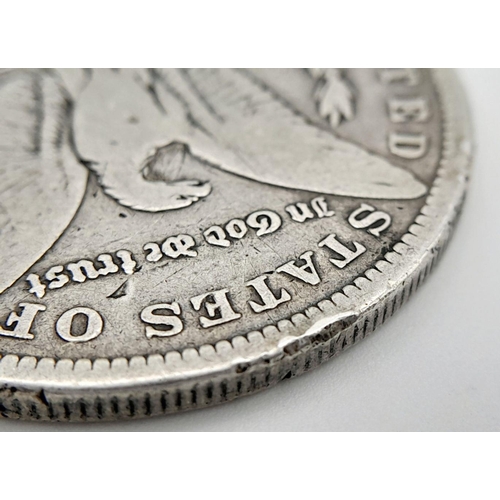 1169 - An 1884 Fine Condition Morgan Silver Dollar. New Orleans Mint. 25.94 Grams.