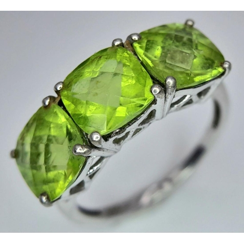 1183 - A Gallery Set Sterling Silver Peridot Trilogy Ring Size N. Set with 7mm Square Cut Peridots the Ring... 