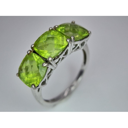 1183 - A Gallery Set Sterling Silver Peridot Trilogy Ring Size N. Set with 7mm Square Cut Peridots the Ring... 