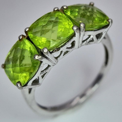 1183 - A Gallery Set Sterling Silver Peridot Trilogy Ring Size N. Set with 7mm Square Cut Peridots the Ring... 