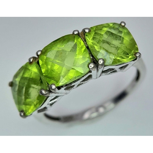 1183 - A Gallery Set Sterling Silver Peridot Trilogy Ring Size N. Set with 7mm Square Cut Peridots the Ring... 