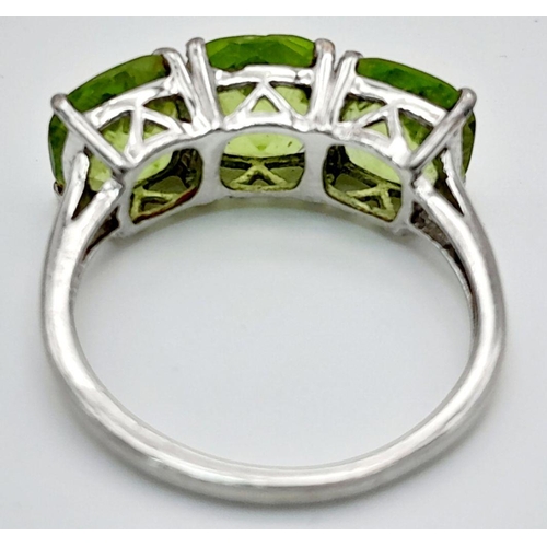 1183 - A Gallery Set Sterling Silver Peridot Trilogy Ring Size N. Set with 7mm Square Cut Peridots the Ring... 