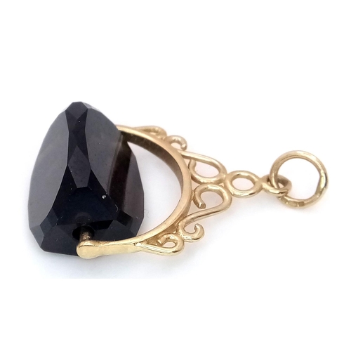 1216 - A 9K Yellow Gold Smoky Quartz Spinning Fob Pendant. 2.5cm. 3g total weight.