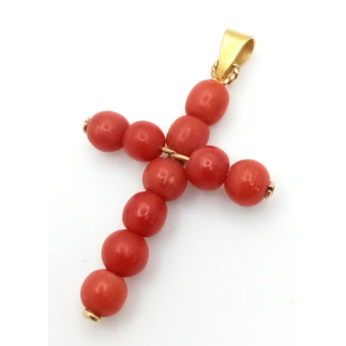 1319 - An 18K Yellow Gold and Coral Cross Pendant. 3.8cm length, 2.23g total weight.