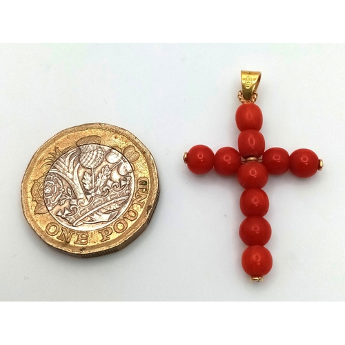 1319 - An 18K Yellow Gold and Coral Cross Pendant. 3.8cm length, 2.23g total weight.