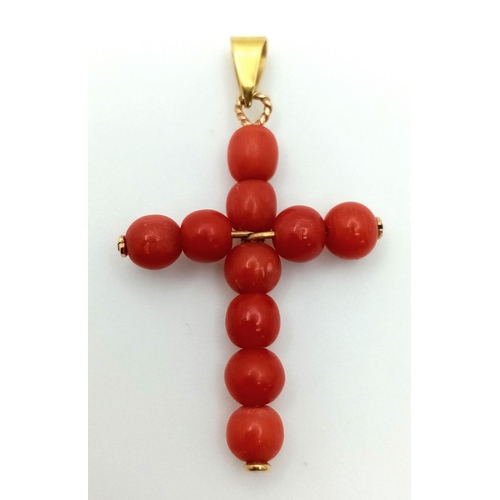 1319 - An 18K Yellow Gold and Coral Cross Pendant. 3.8cm length, 2.23g total weight.