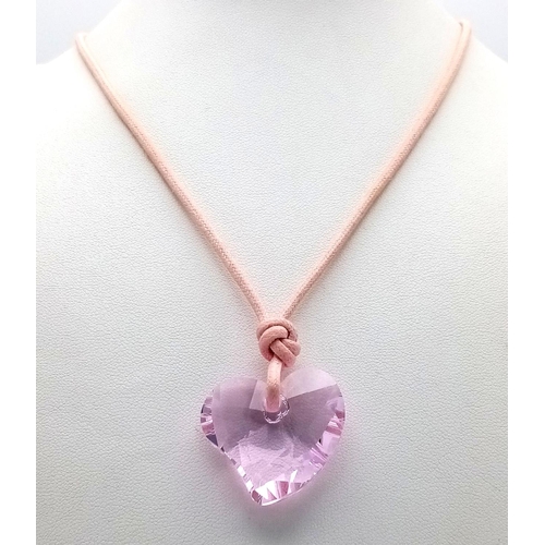 1375 - A SWAROVSKI PURPLE HEART PENDANT WITH ORIGINAL BOX, 26MM X 29MM PENDANT. Ref: SAM 7002