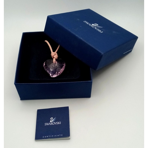 1375 - A SWAROVSKI PURPLE HEART PENDANT WITH ORIGINAL BOX, 26MM X 29MM PENDANT. Ref: SAM 7002