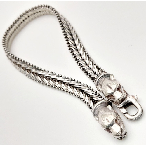 1403 - A STERLING SILVER FANCY LINK BRACELET, WITH JAGUAR HEAD . 16.6G TOTAL WEIGHT, 19.5CM IN LENGTH. Ref:... 