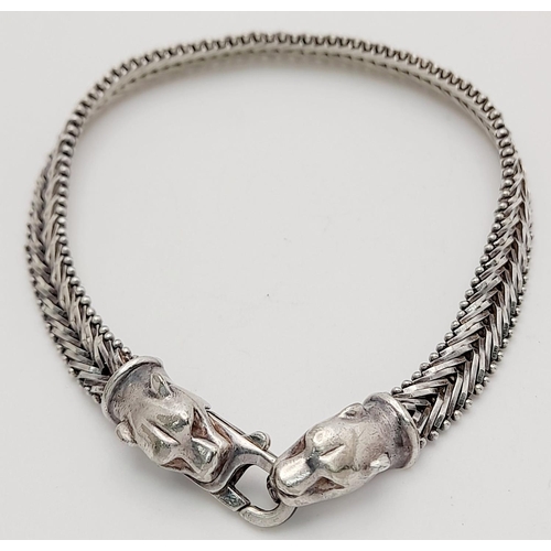 1403 - A STERLING SILVER FANCY LINK BRACELET, WITH JAGUAR HEAD . 16.6G TOTAL WEIGHT, 19.5CM IN LENGTH. Ref:... 