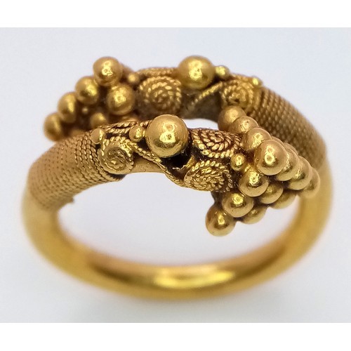 163 - An 18K Gold Etruscan Style Crossover Ring. Size F. 8.2g.