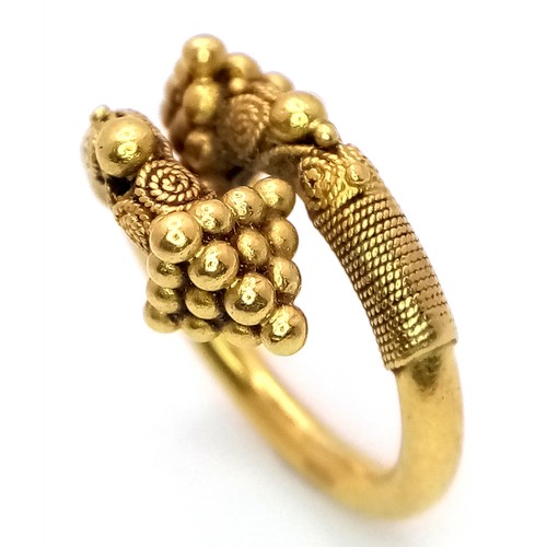 163 - An 18K Gold Etruscan Style Crossover Ring. Size F. 8.2g.