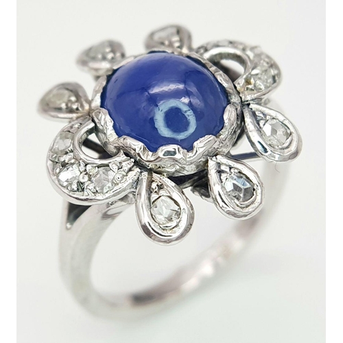 1714 - AN 18K WHITE GOLD DIAMOND & STAR SAPPHIRE RING. 6.3G IN WEIGHT. SIZE O AND 1/2. Ref: 8808