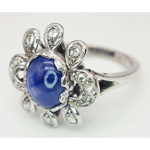 1714 - AN 18K WHITE GOLD DIAMOND & STAR SAPPHIRE RING. 6.3G IN WEIGHT. SIZE O AND 1/2. Ref: 8808