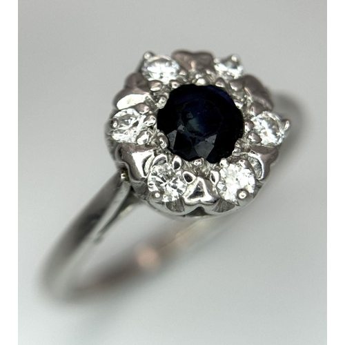 2181 - AN 18K WHITE GOLD DIAMOND & SAPPHIRE CLUSTER RING 4.2G SIZE O 1/2. Ref: SC 6024