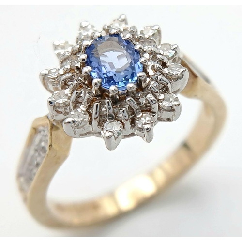 2064 - A 9K YELLOW GOLD DIAMOND AND BLUE TOPAZ CLUSTER RING. 3.5G. SIZE M. GW7