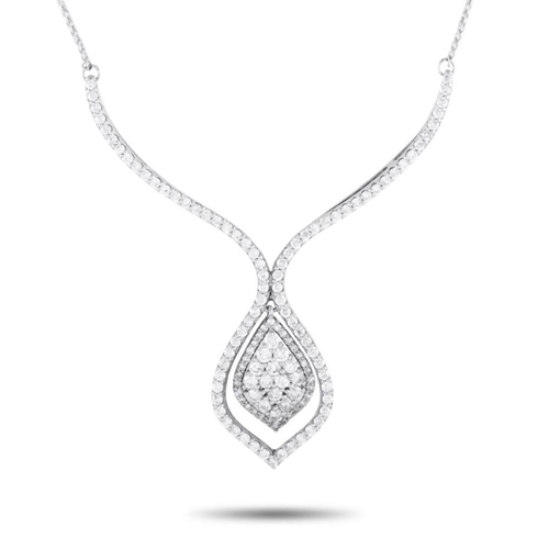 1072 - A 14K White Gold 1.50ct Diamond Necklace. It features a cluster of diamonds on a stylized and haloed... 