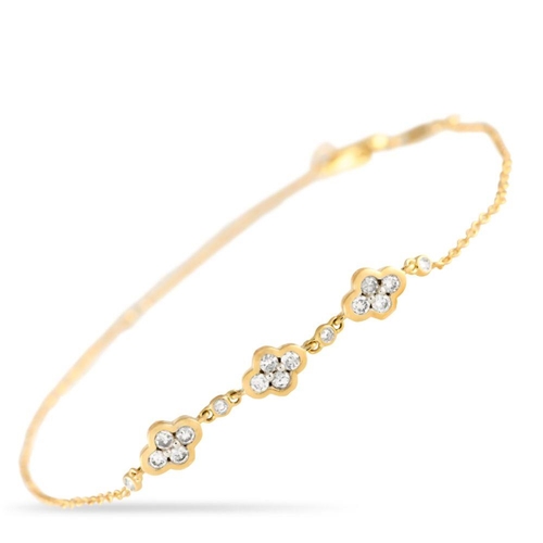 869 - A 14K Yellow Gold 0.25ct Diamond Quatrefoil Bracelet. At the center of the chain, lustrous quatrefoi... 