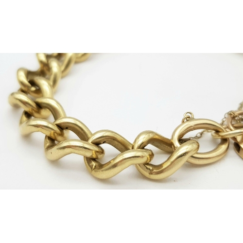 1075 - A Chunky 9K Yellow Gold Curb Link Bracelet with Heart Clasp. 18cm. 50.5g weight.