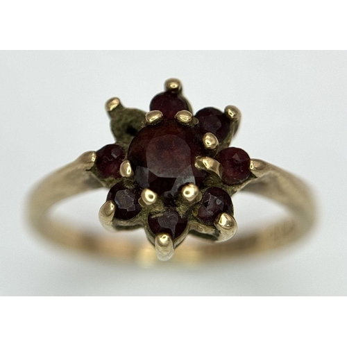 2440 - A Vintage 9K Yellow Gold Garnet Ring. Floral form. Size K. 2.2g total weight. As found.