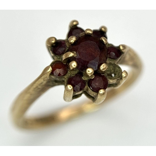 2440 - A Vintage 9K Yellow Gold Garnet Ring. Floral form. Size K. 2.2g total weight. As found.