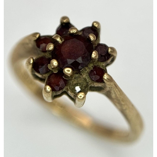 2440 - A Vintage 9K Yellow Gold Garnet Ring. Floral form. Size K. 2.2g total weight. As found.