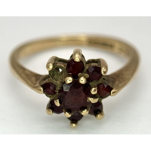 2440 - A Vintage 9K Yellow Gold Garnet Ring. Floral form. Size K. 2.2g total weight. As found.