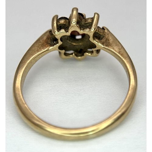 2440 - A Vintage 9K Yellow Gold Garnet Ring. Floral form. Size K. 2.2g total weight. As found.