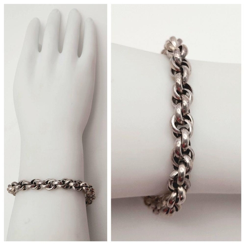 2438 - An Intricate Link Sterling Silver Bracelet. T-bar clasp. 19cm. 30g weight.