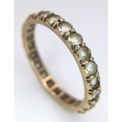 2434 - A 9K Yellow Gold Stone Set Eternity Ring. Size L. 1.75g total weight.