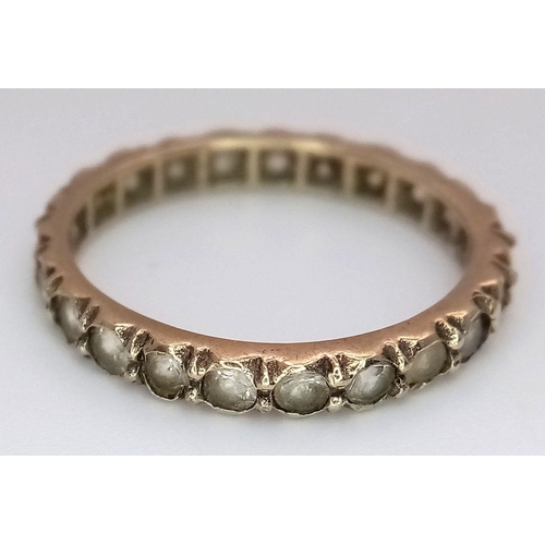 2434 - A 9K Yellow Gold Stone Set Eternity Ring. Size L. 1.75g total weight.