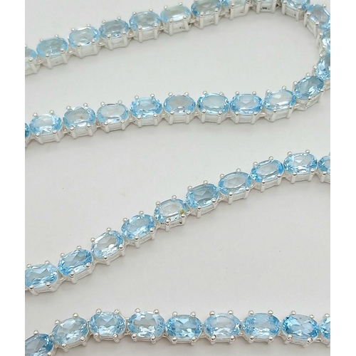 1486 - A Blue Topaz Gemstone Tennis Necklace. Set in 925 Silver. 44cm. CD-1597