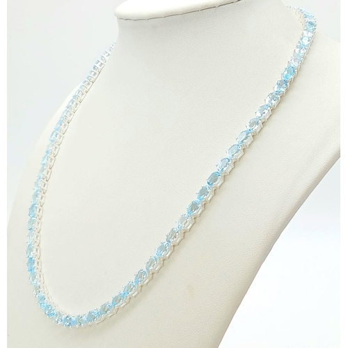 1486 - A Blue Topaz Gemstone Tennis Necklace. Set in 925 Silver. 44cm. CD-1597