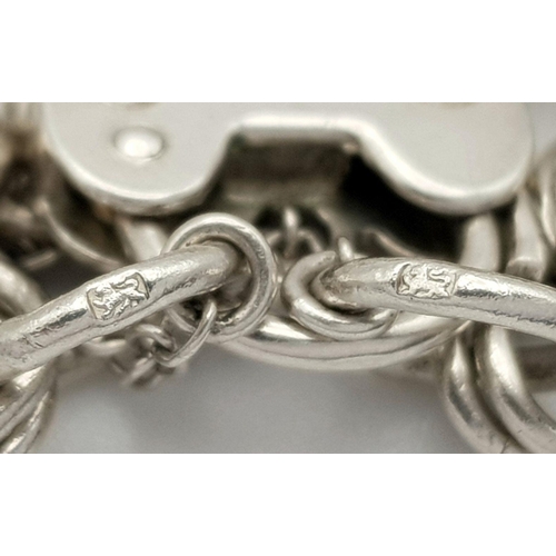 1522 - A vintage Solid Silver 925 Charm Bracelet, with 16 charms,� 45.9 grams, 18cm, Heart padlock and safe... 