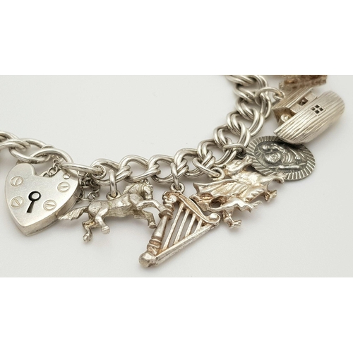 1522 - A vintage Solid Silver 925 Charm Bracelet, with 16 charms,� 45.9 grams, 18cm, Heart padlock and safe... 