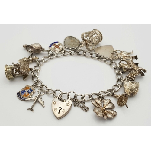 1550 - A vintage Solid Silver 925 Charm Bracelet, with 14 charms, 45.4 grams, 17.5cm, Heart padlock and saf... 