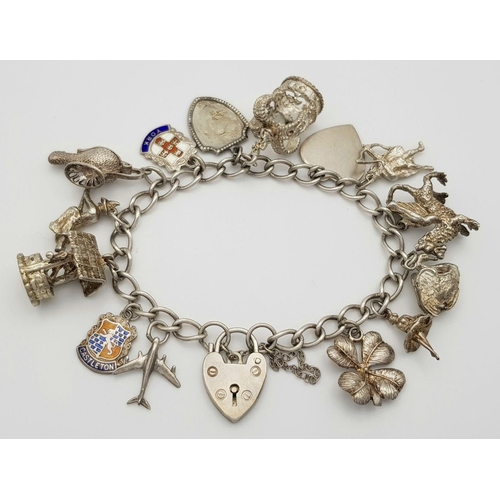 1550 - A vintage Solid Silver 925 Charm Bracelet, with 14 charms, 45.4 grams, 17.5cm, Heart padlock and saf... 