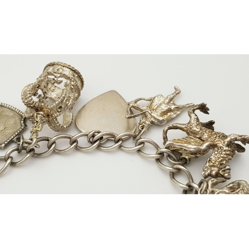 1550 - A vintage Solid Silver 925 Charm Bracelet, with 14 charms, 45.4 grams, 17.5cm, Heart padlock and saf... 