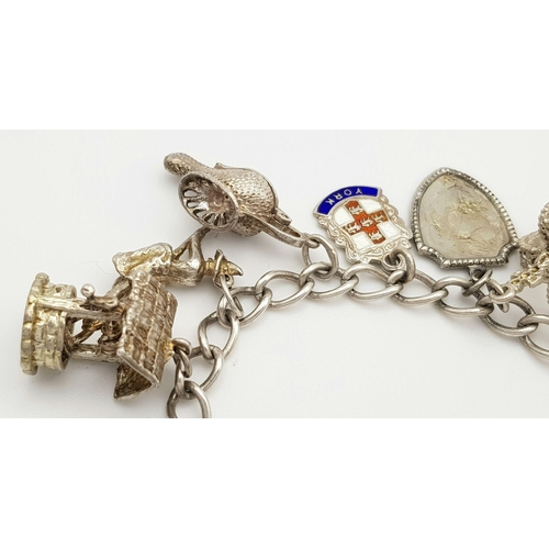 1550 - A vintage Solid Silver 925 Charm Bracelet, with 14 charms, 45.4 grams, 17.5cm, Heart padlock and saf... 