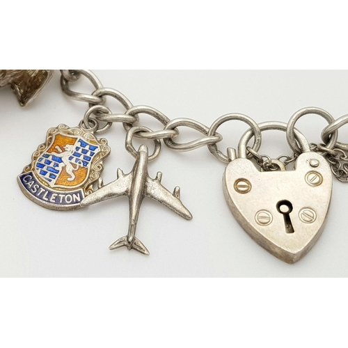 1550 - A vintage Solid Silver 925 Charm Bracelet, with 14 charms, 45.4 grams, 17.5cm, Heart padlock and saf... 