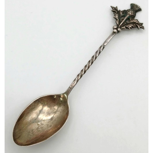 1552 - An antique sterling silver souvenir Thistle spoon with curved handle. Full Edinburgh hallmarks, 1918... 